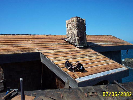 The stripped wood roof area on the upper level of this multi-level home